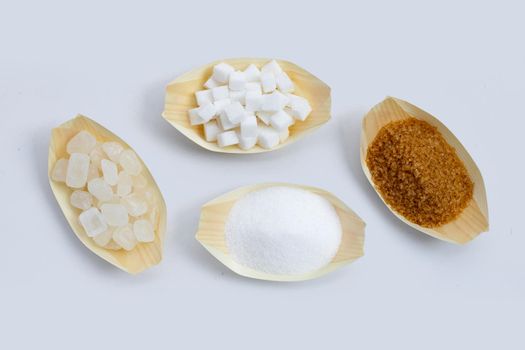 Various types of sugar on white background.