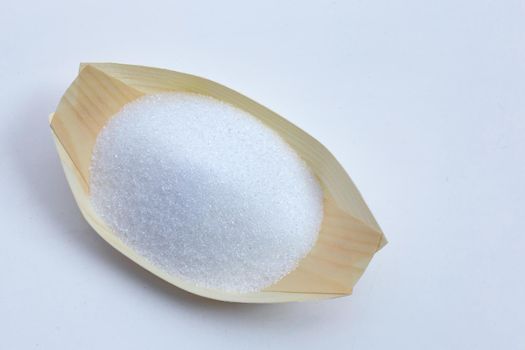 White granulated sugar on white background. Copy space