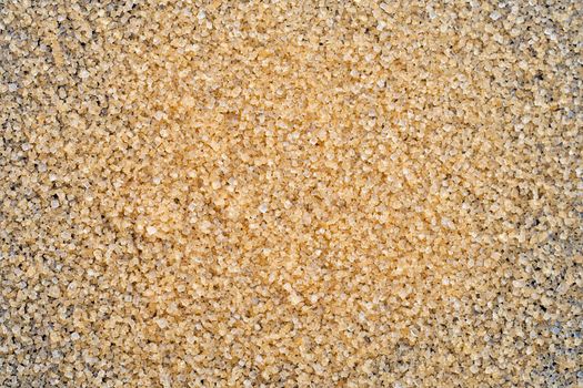 Brown sugar on dark background. 