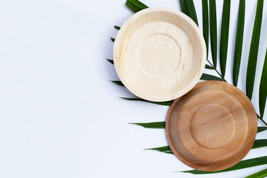 Betel palm leaf plates on white background.