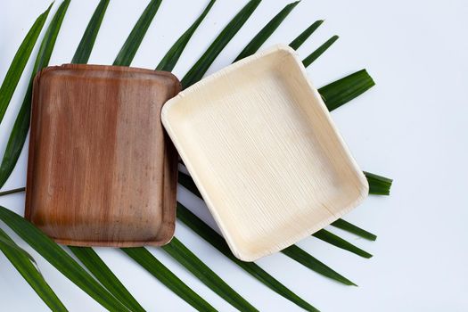 Betel palm leaf plates on white background.