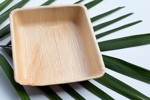 Betel palm leaf plate on white background.