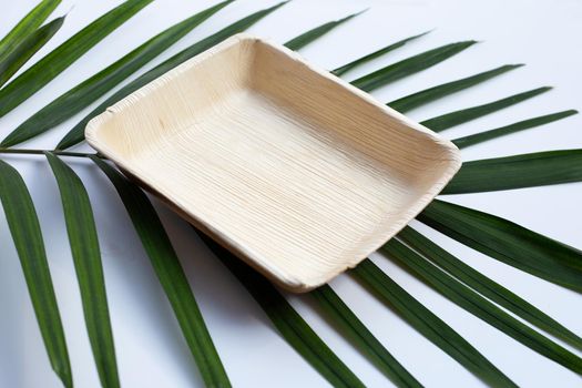 Betel palm leaf plate on white background.