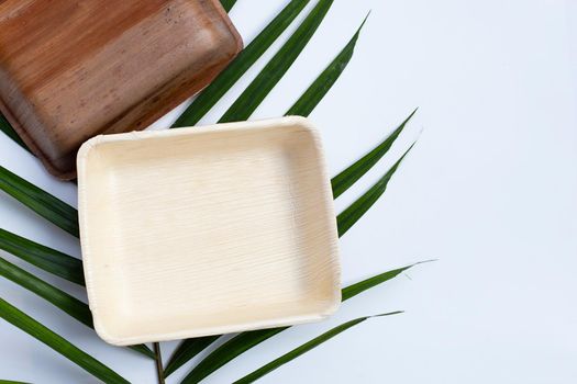 Betel palm leaf plates on white background.