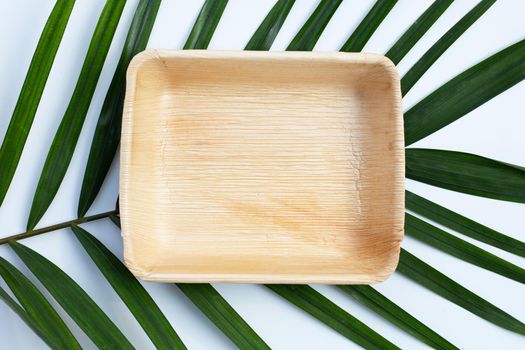 Betel palm leaf plate on white background.