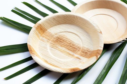 Betel palm leaf plates on white background.