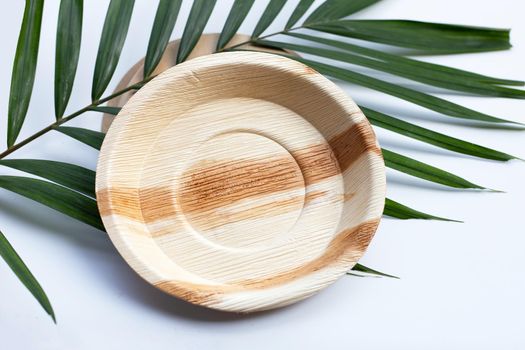Betel palm leaf plates on white background.