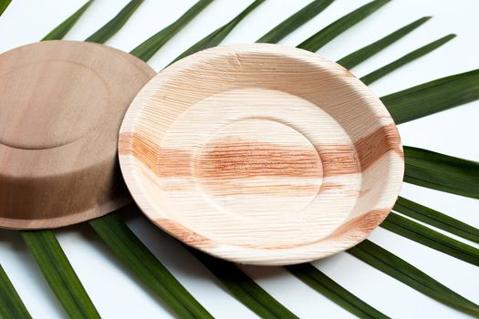 Betel palm leaf plates on white background.