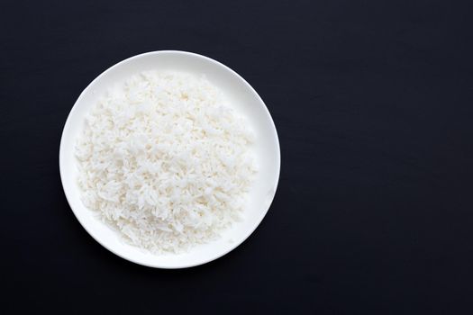 Dish of rice on dark background.