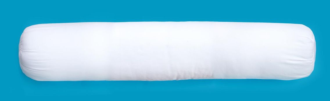 White bolster pillow on blue background.