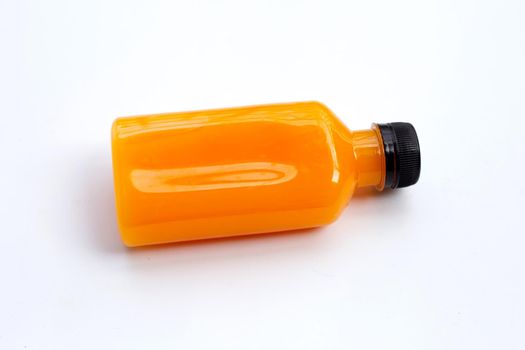 Orange juice in plastic bottle on white background. 