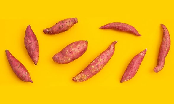 Sweet potato on yellow background. Top view
