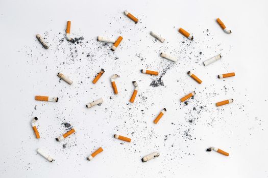 Cigarette butts and ashes on white background.
