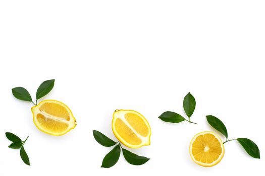 Fresh lemon with green leaves on white background.