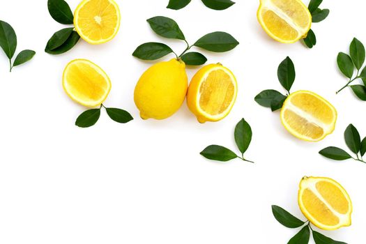 Fresh lemon with green leaves on white background.