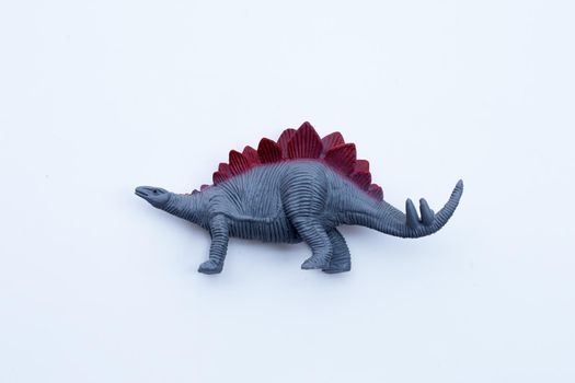 Plastic dinosaur toy on white background. 