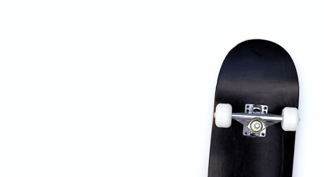 Black skateboard on white background.