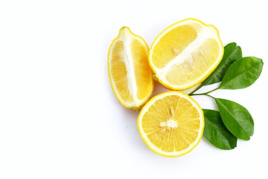 Fresh lemon with green leaves on white background.