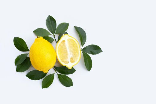 Fresh lemon with green leaves on white background.