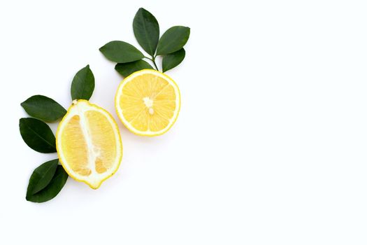 Fresh lemon with green leaves on white background.