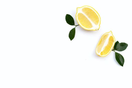 Fresh lemon with green leaves on white background.