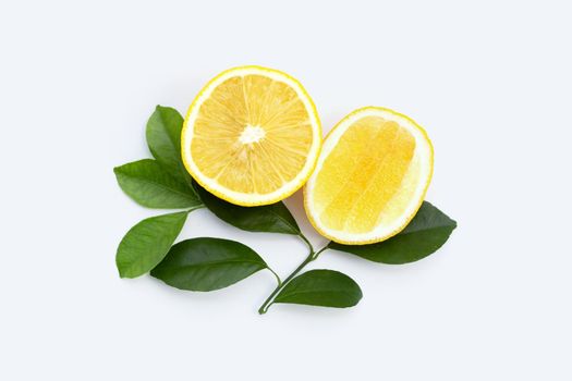 Fresh lemon with green leaves on white background.