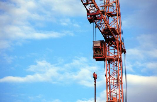 Composition of modern construction with building walls and crane