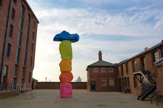 Liverpool, United Kingdom, 2nd February, 2020: Natural perspective of the colorful Liverpool mountain sculpture outside the Tate gallery in Liverpool