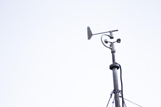 Weather station in silhouette over the sky at sunset. No people