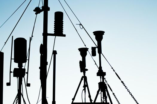 Weather station in silhouette over the sky at sunset. No people