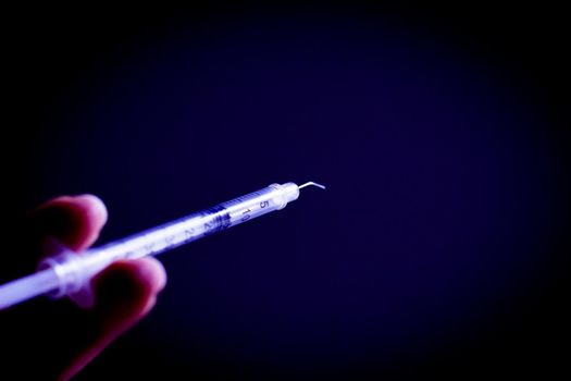 Syringe with insulin to be injected. Copy space