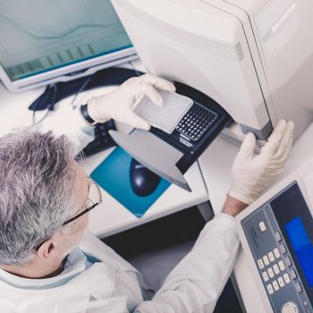 Life science researcher performing a genotyping testing which enables personalized medicine. PM is a medical model that proposes the customization of healthcare.