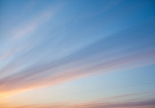 Colorful sunset or sunrise in the sky. The sky and clouds are painted in different delicate colors.