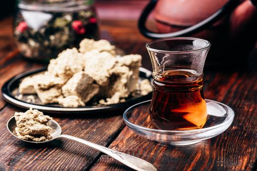 Black tea in armudu glass and spoonful of sunflower halva