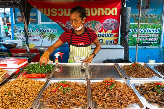 Asian food market. A counter with fried insects.