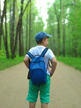 The boy is traveling with a backpack on his back. Travel and tourism. 