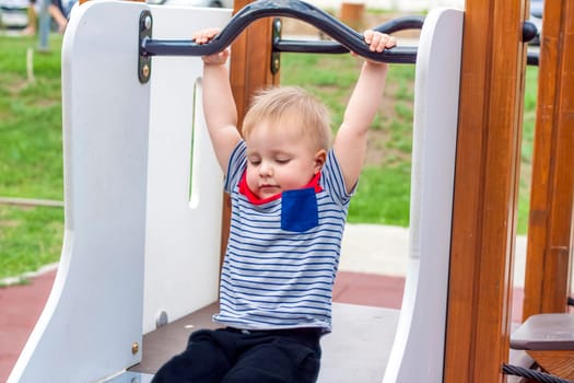 A little boy enthusiastically playing on the Playground. Success, creative ideas and sports concepts. The concept of an advertising banner.