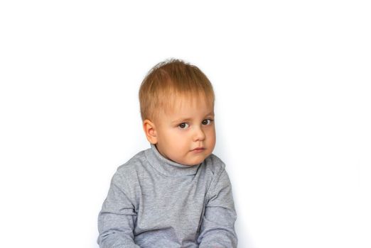 Portrait of a cute little boy. The child is isolated on a white background. Success, bright idea, creative ideas and innovative technological concepts. The concept of an advertising banner.