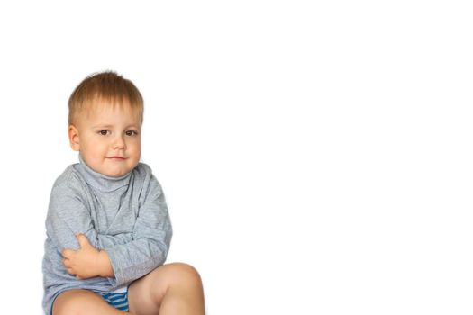 Portrait of a cute, funny boy. The boy poses on a white background. The expression on his face. Portrait