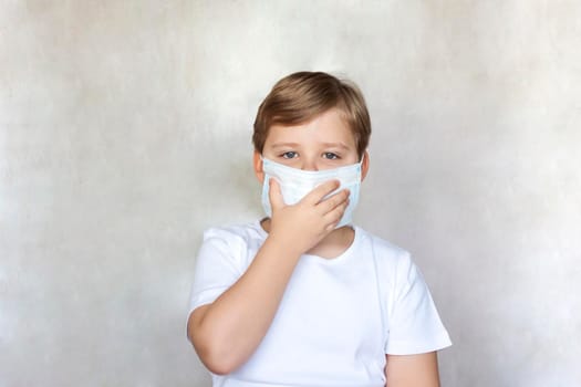 A boy in a medical mask. Coronavirus, disease, infection, quarantine, medical mask, COVID-19. Quarantine and protection from influenza viruses and epidemics covid-19. Coronavirus quarantine.