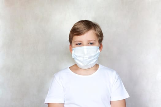 A boy in a medical mask. Coronavirus, disease, infection, quarantine, medical mask, COVID-19. Quarantine and protection from influenza viruses and epidemics covid-19. Coronavirus quarantine.