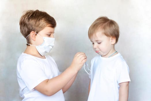 A boy in a medical mask. Coronavirus, disease, infection, quarantine, medical mask, COVID-19. Quarantine and protection from influenza viruses and epidemics covid-19. Coronavirus quarantine.