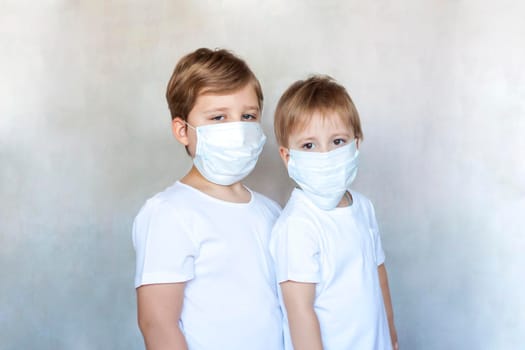 Boys-brothers in medical masks. Coronavirus, disease, infection, quarantine, medical mask, COVID-19. Quarantine and protection from influenza viruses and epidemics covid-19. Coronavirus quarantine.