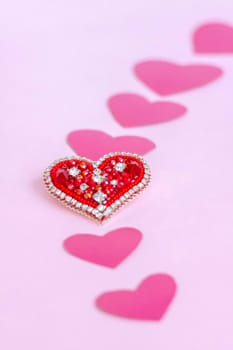 Red heart made of beads. Pink hearts. The concept of the Valentine's Day theme. A greeting card, a declaration of love. February 14