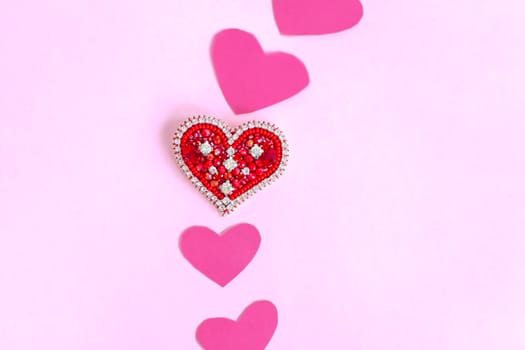 Red heart made of beads. Pink hearts. The concept of the Valentine's Day theme. A greeting card, a declaration of love. February 14