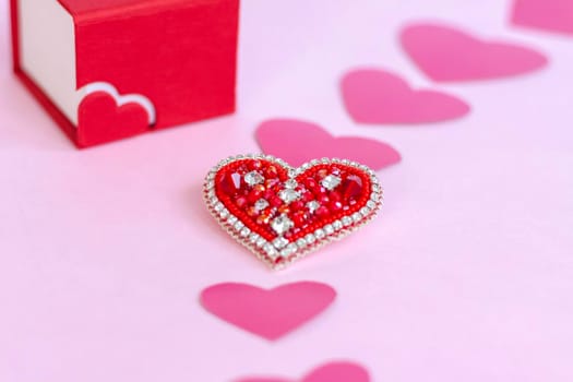 Red heart made of beads. Pink hearts. The concept of the Valentine's Day theme. A greeting card, a declaration of love. February 14