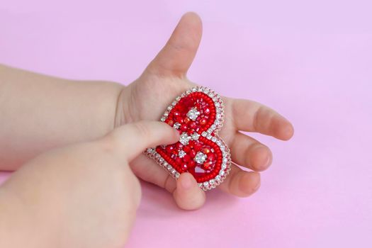 Red heart on the palm of your hand. The concept of the Valentine's Day theme. A greeting card, a declaration of love. February 14  