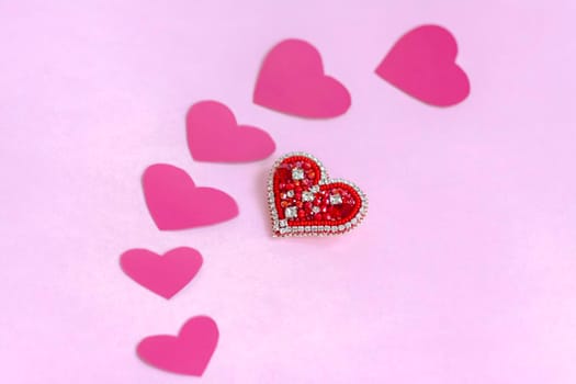 Red heart made of beads. Pink hearts. The concept of the Valentine's Day theme. A greeting card, a declaration of love. February 14  