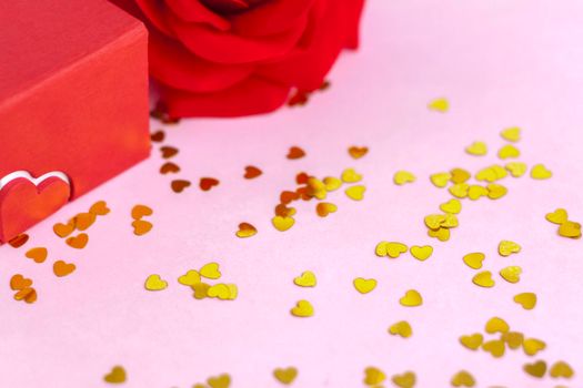 Pink background with gold hearts, sequins. The concept of the Valentine's Day theme. Postcard, template, background for graphic works