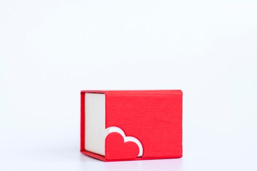 Red box for decoration with a heart on a white background. Make a Declaration of love. The concept of the Valentine's Day theme. Isolate. 